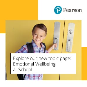 children smiling on the beach with a beach ball