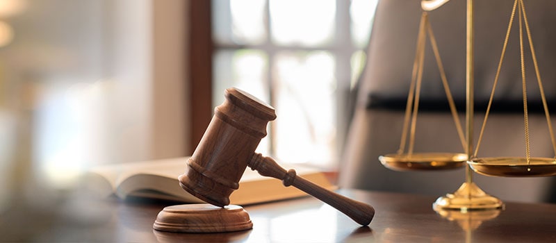 judge gavel, law books and scales of justice on desk in lawyer office. legal justice concept. 